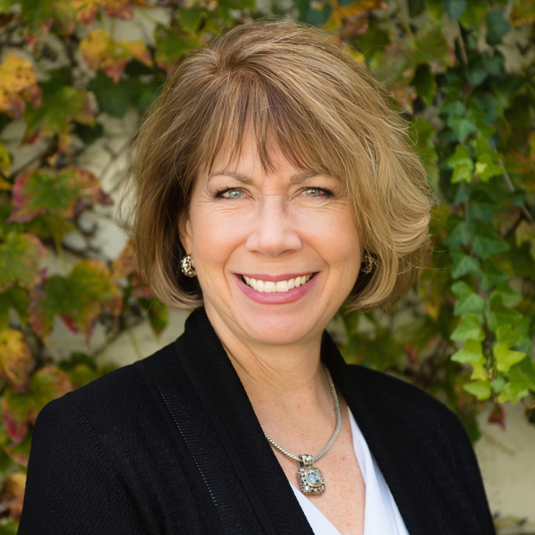 A warm portrait of Dr. Kimberly Harms award-winning author, international speaker, and two-time breast cancer survivor radiating strength and compassion.