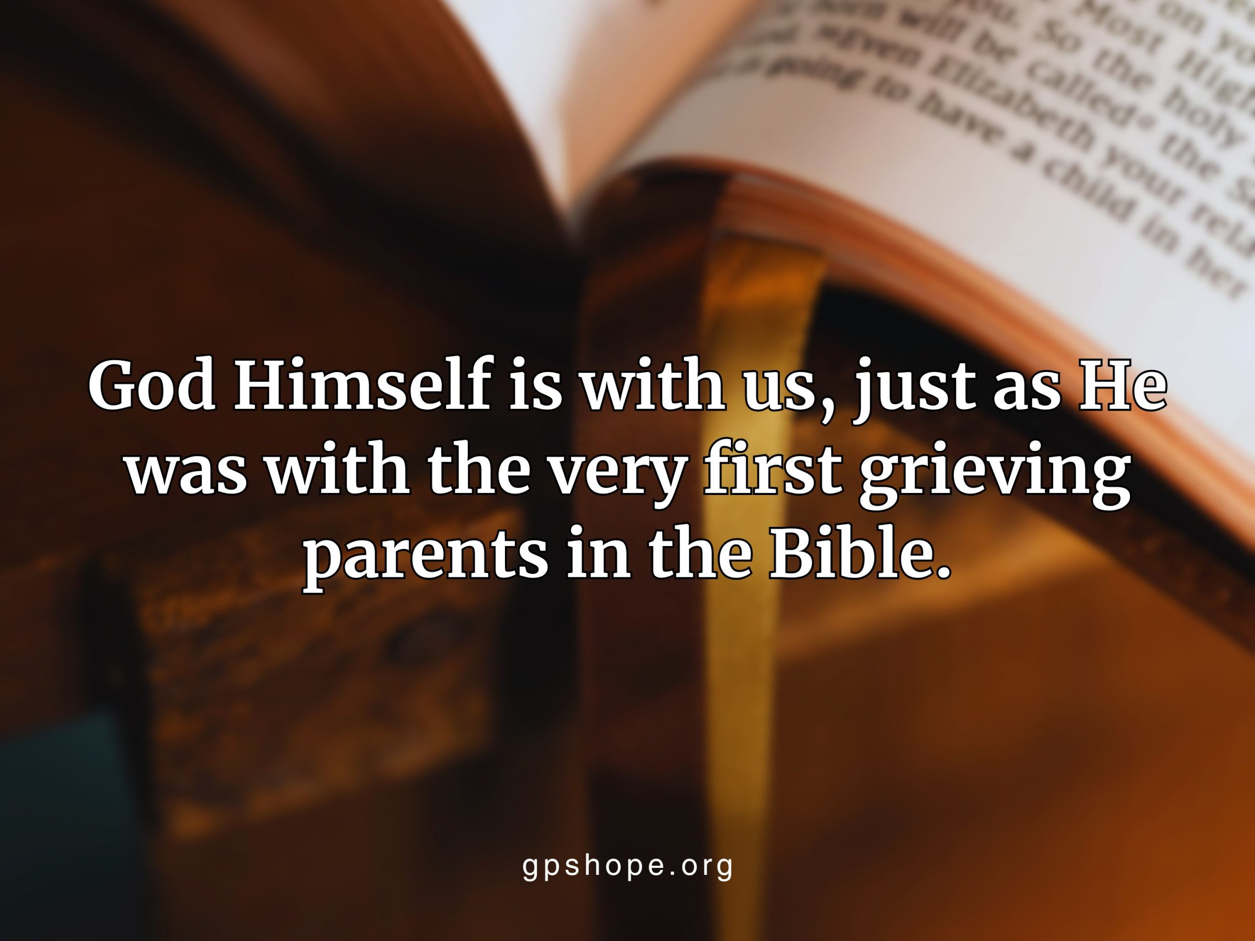 Blurred Bible on wooden surface with text: “God Himself is with us, just as He was with the very first grieving parents in the Bible.” GPS Hope - Grieving Parents Sharing HOPE