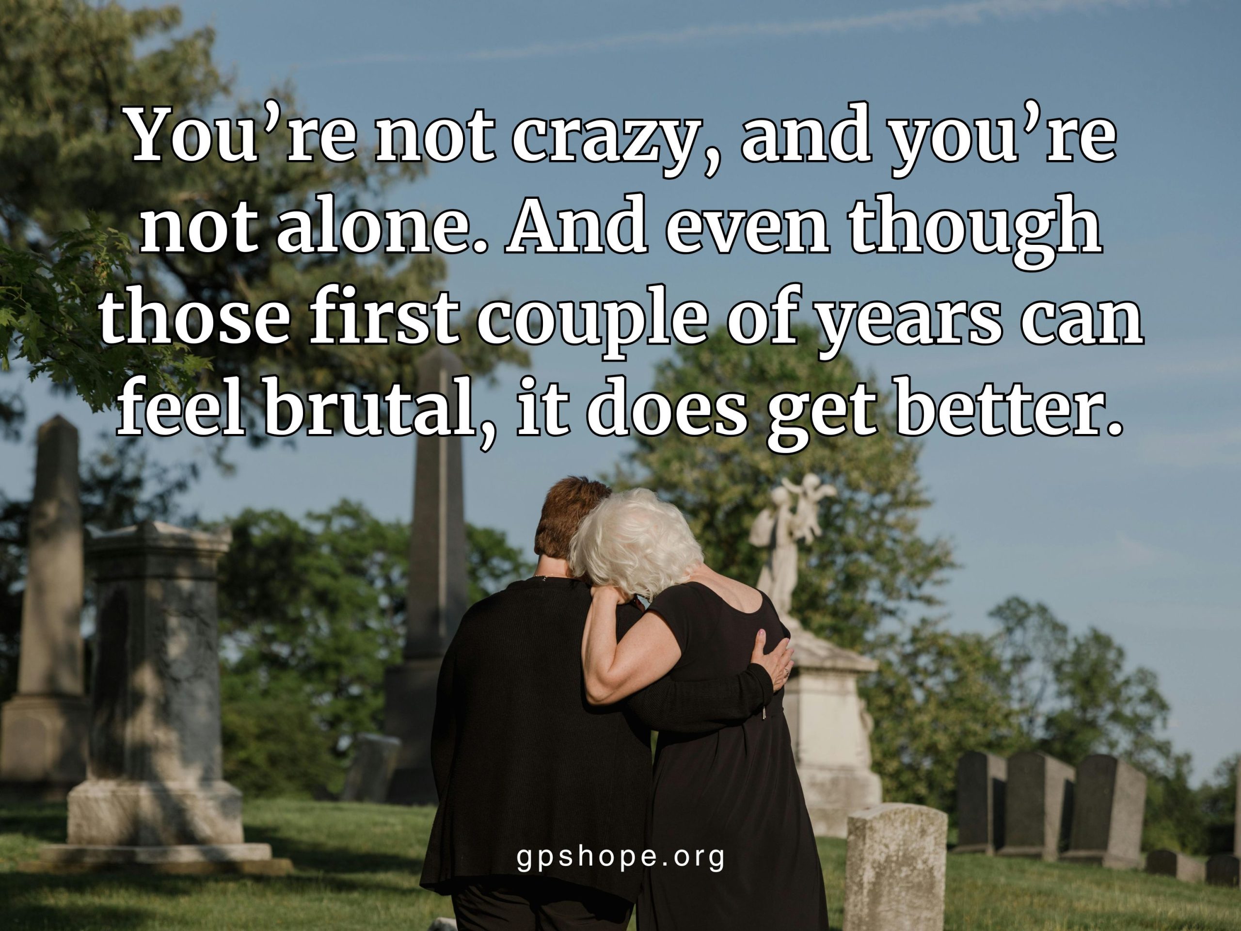 Comforting embrace in a cemetery, symbolizing support in grief